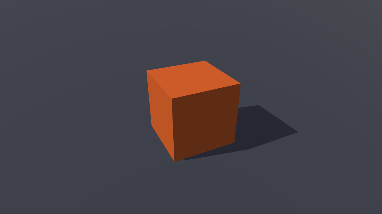 An orange cube casting a soft shadow on a dark grey floor, lit from the upper left, seen from slightly above.